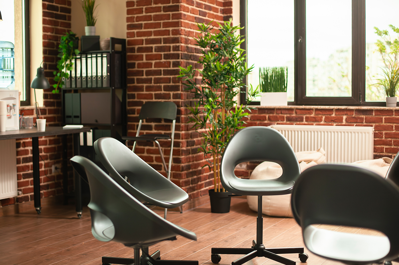 Two armchairs in a calm, plant-filled consulting room